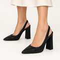 Model wearing black rhinestone slingback shoes